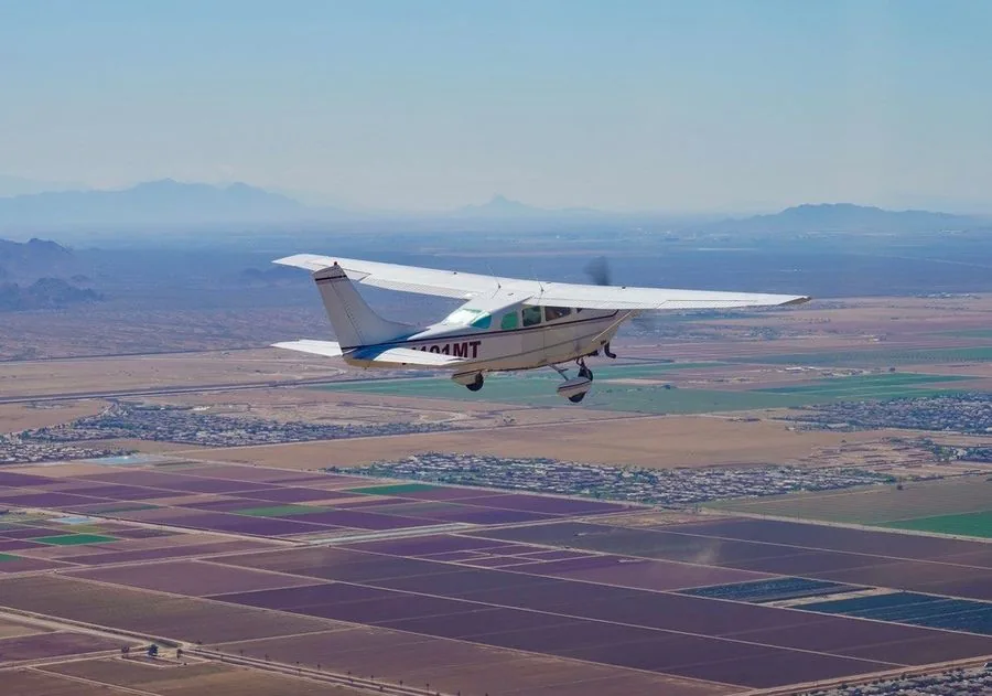 Cessna survey aircraft over agricultural and mining terrain