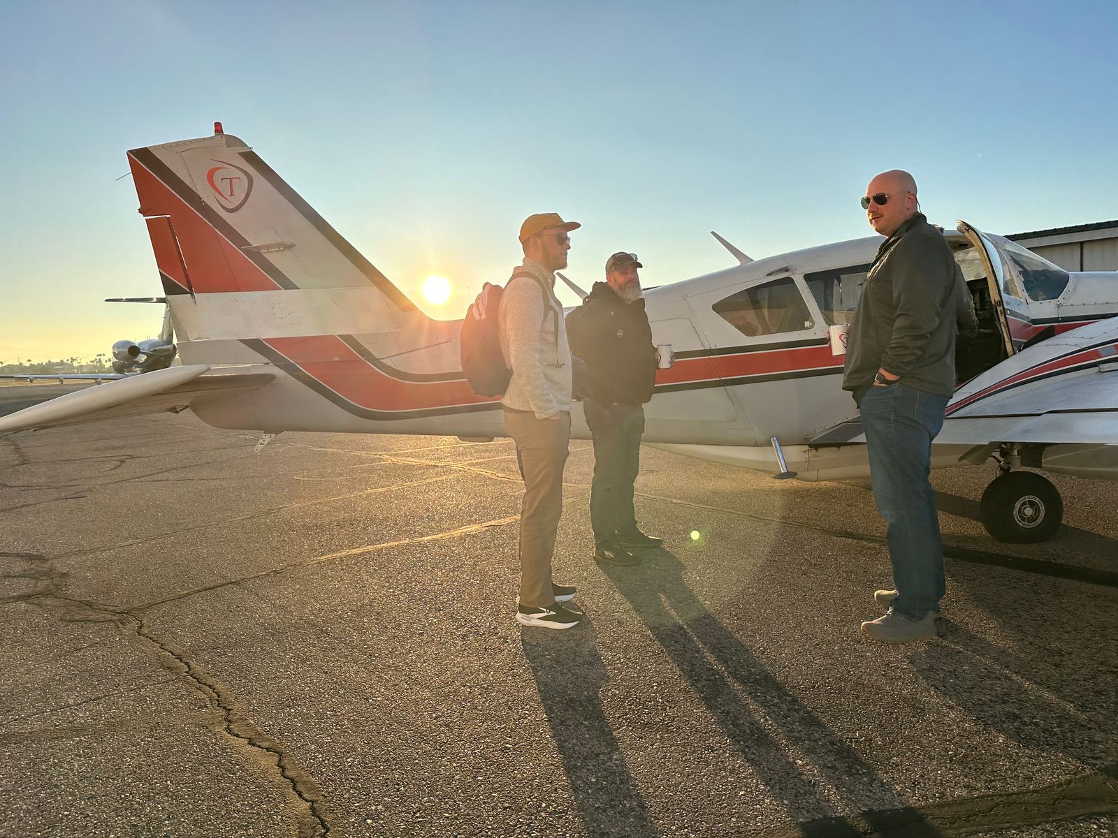 Talos Aviation crew at sunrise preflight briefing